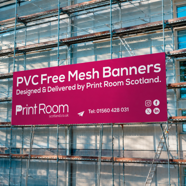 PVC-free mesh banner by Print Room Scotland displayed on scaffolding at a construction site.