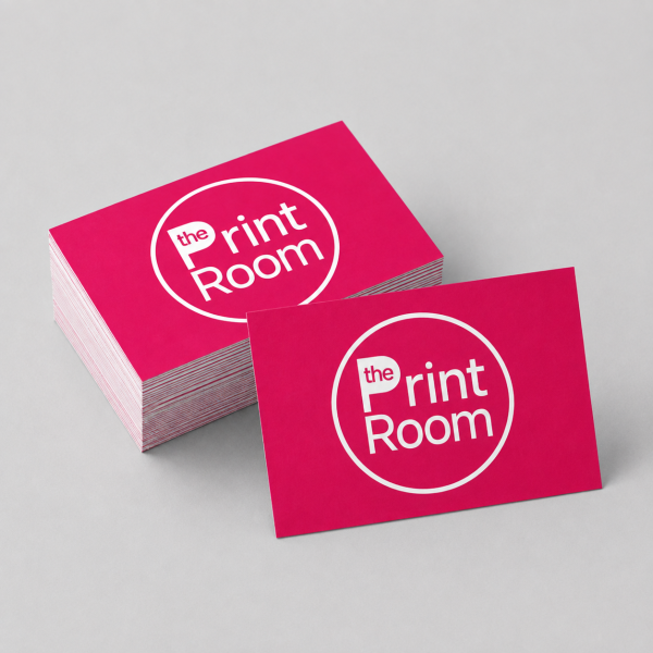 Premium business cards featuring The Print Room circular logo in white on a vibrant magenta background, with a stacked set and a single card displayed on a neutral grey studio surface.