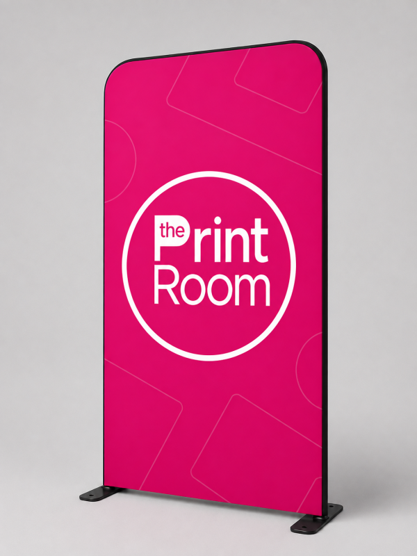 Freestanding pop-up exhibition display featuring The Print Room round magenta logo with the word "the" inside the white letter "P", displayed on a vibrant pink background with subtle geometric line patterns against a neutral grey studio backdrop.