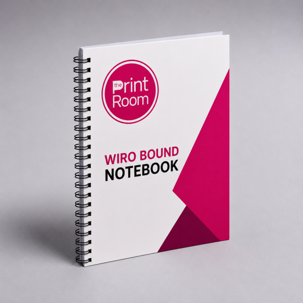 White wiro bound notebook featuring The Print Room round magenta logo on the front cover with bold black and magenta typography, modern geometric magenta accents, and a black spiral binding on a neutral grey studio background.