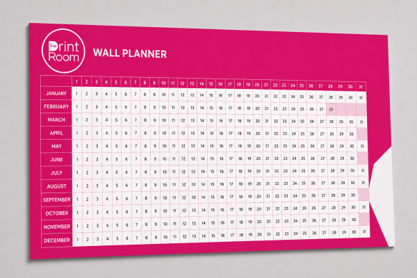 Year wall planner featuring the Print Room circular logo, with monthly rows, numbered days 1 to 31 and a vibrant pink branded design, displayed on a light grey studio background.