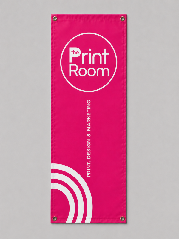 Pink custom fabric banner with eyelets featuring The Print Room branding and printed graphics.