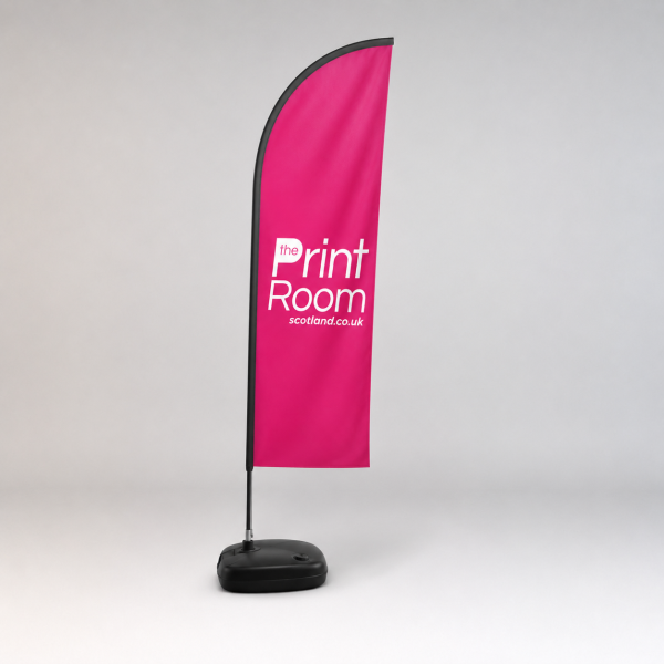 Wind Dancer promotional flag display with The Print Room branding on a pink flag, mounted on a freestanding outdoor base against a light grey studio background.